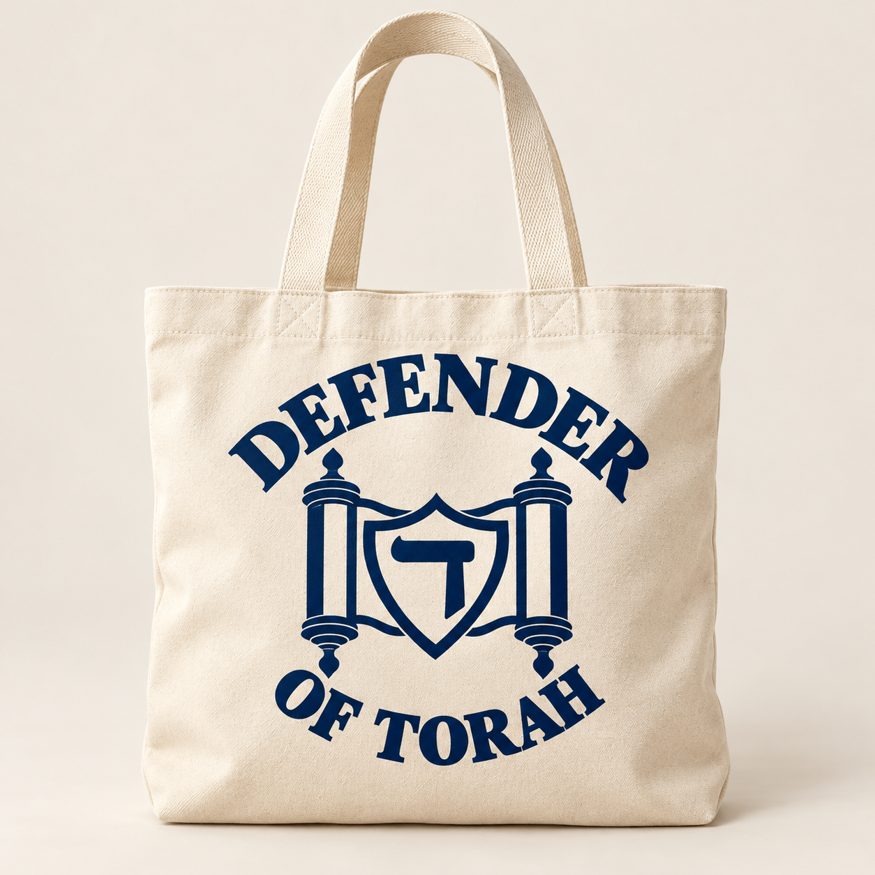 The Everyday Tote design preview in cream / navy, with the full Defender of Torah logo